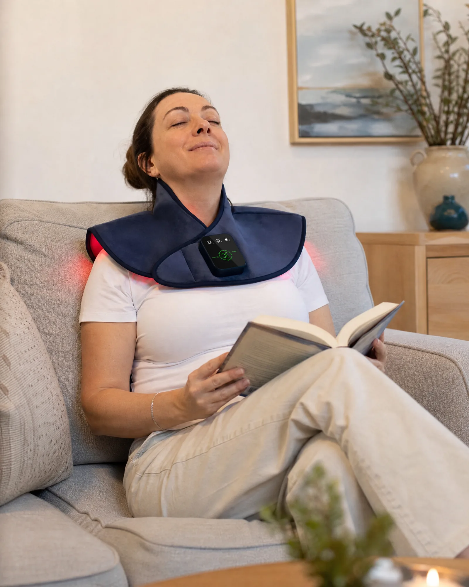 Woman relaxing at home while wearing a CAREMORR red light therapy wrap